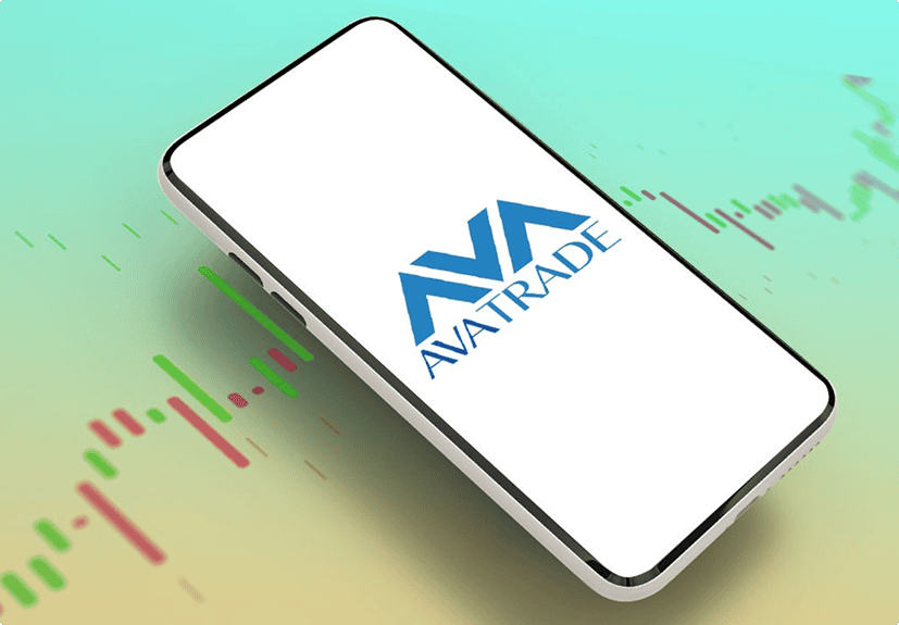 A smartphone displaying the AvaTrade logo on its screen, placed over a background with green and red candlestick chart graphics.