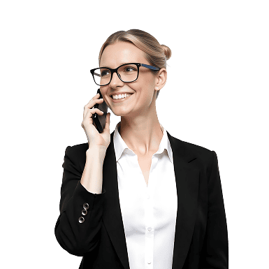 A woman wearing glasses and a black blazer smiles while talking on a smartphone against a plain white background.