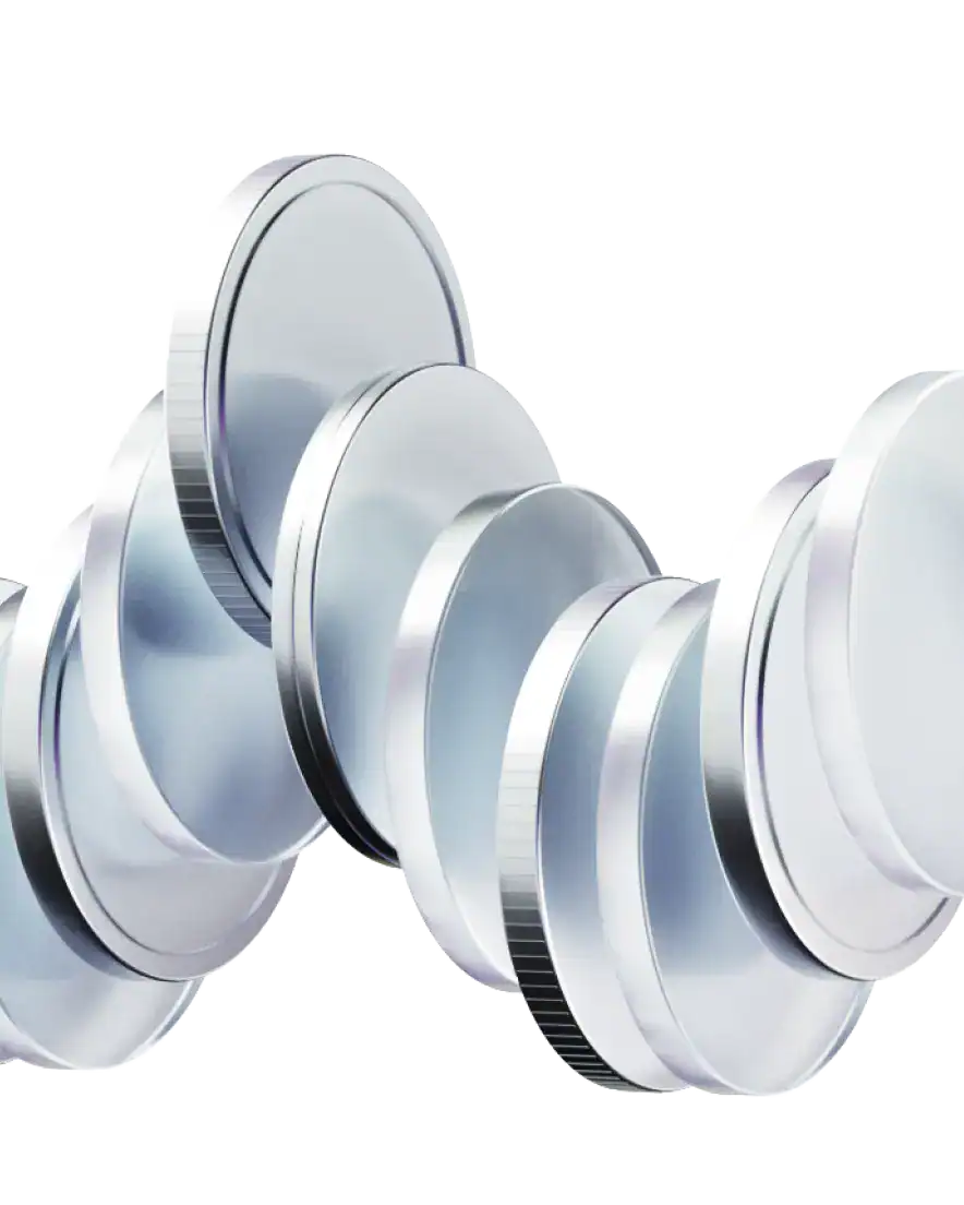 A row of shiny, silver coins stands on their edges, leaning against each other in a curved arrangement—evoking the dynamic nature of trading and modern financial tools like crypto.